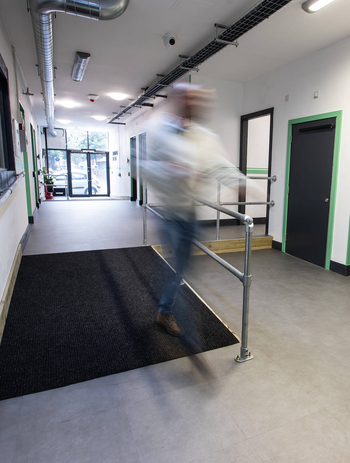 Cymru Broadcast Centre hallway with a man passing over the ramp